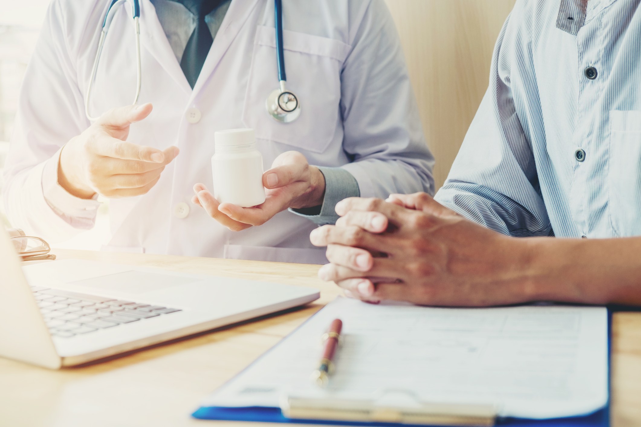 Doctor or physician recommend pills medical prescription to male Patient